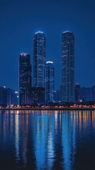 Obraz premium Illuminated Skyscrapers Reflecting on Water at Night in a Modern Cityscape