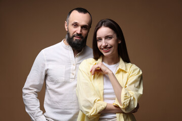 Portrait of happy daughter and father on brown background