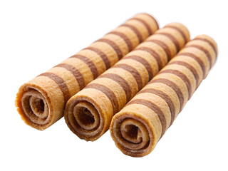 Three brown striped wafer rolls isolated on transparent background