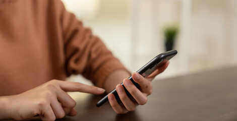 Hand holding smartphone with using social media.