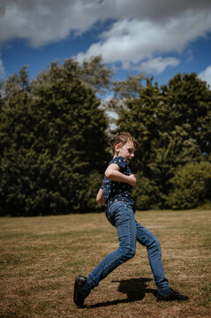 A boy kicks a soccer ball.