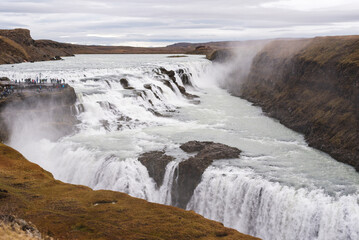 Tourists gather to overlook Gullfoss waterfall in Iceland