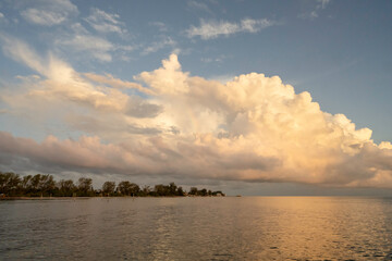 Rainbow in white clouds over Anna Maria Island, Florida