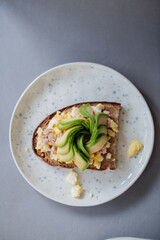 Tasty avocado toast with fried egg