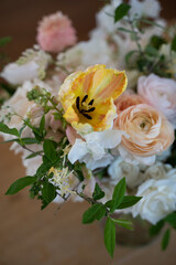 Vibrant yellow tulip highlighted in a soft spring bouquet
