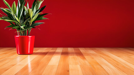 Fototapeta premium Green Plant in Red Pot on Wooden Floor Against Red Wall