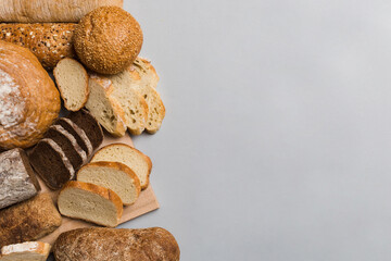 Homemade natural breads. Different kinds of fresh bread as background, top view with copy space
