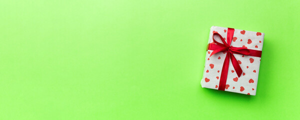 Background with gift box and hearts on green Background. Top view with copy space for text