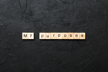 my purposes word written on wood block. my purposes text on cement table for your desing, concept