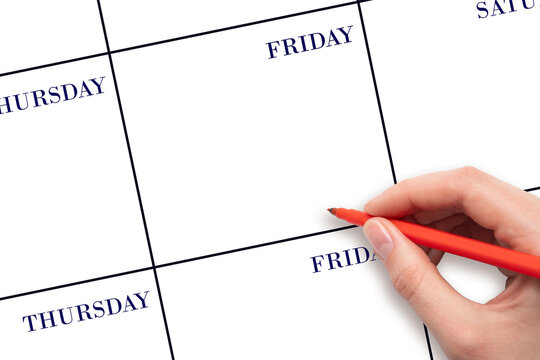 FRIDAY. Hand holding red pen writing in blank Friday cell of a weekly calendar layout on clean white background, planning or scheduling concept. Save the date.