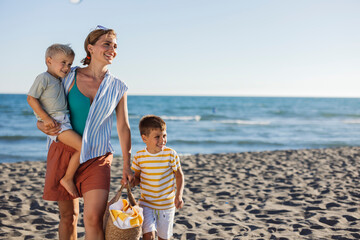Happy family walking on sandy beach enjoying summer vacation