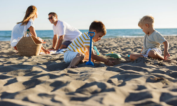 Family enjoying summer vacations playing on the beach