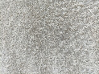 Beige towel texture. Fluffy pile fabric background.