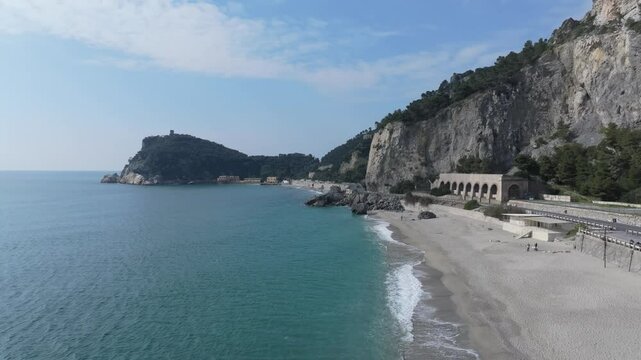 aerial falling away leaving the Spiaggia del Malpasso beach with paid access the coast of western Italy