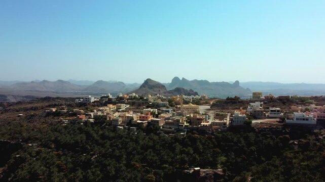 Aerial view of Misfat Al Abriyeen, Oman! Discover historic stone houses, terraces, and the ancient falaj system. Watch now!