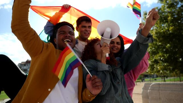 Diverse group of friends standing together, passionately advocating for lgbtq plus rights with rainbow flags and megaphones during vibrant public demonstration