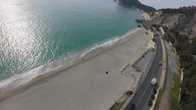 surreal aerial FPV cliff dive to the highway and gorgeous turquoise water beaches at Spiaggia del Malpasso, Italy