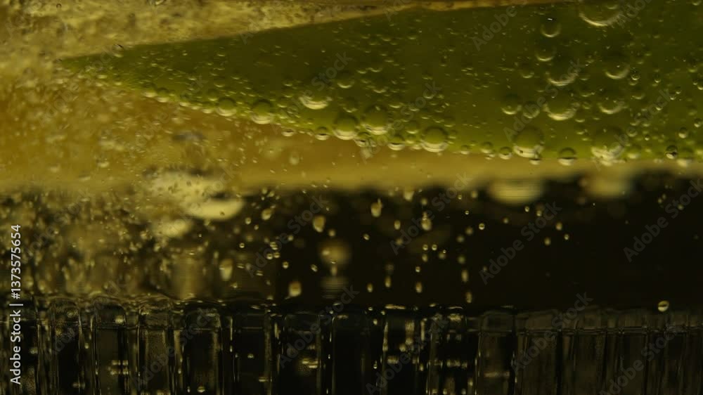 Poster Macro shot of cider bubbles rising past floating apple slices with golden fizz detail