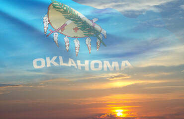 Flag of Oklahoma against the sunset. U.S. state