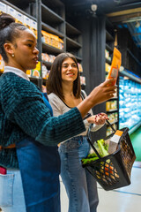 Saleswoman helping customer choosing products in supermarket