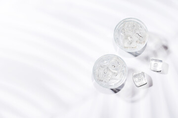 Crystal-clear glasses filled with chilled water and ice cubes