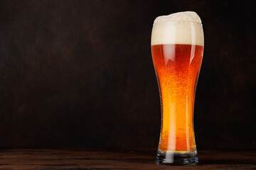 A glass of beer with a frothy head
