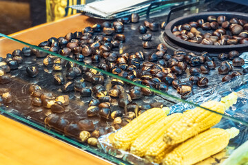  Dubai. Roasted chestnuts being purchased at an oriental bazaar during a bustling market day.