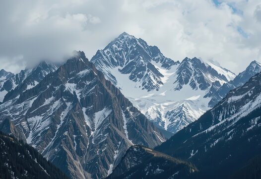 Majestic snow-capped mountains under a cloudy sky during daylight