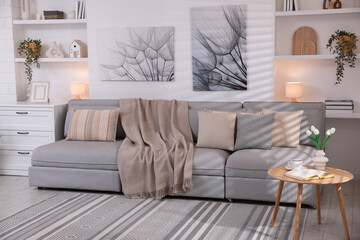 Modern living room interior. Comfortable sofa and decorative elements indoors