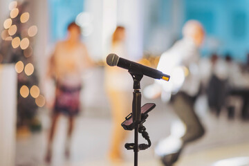 Excitement builds as the microphone stands ready for a lively performance during an elegant evening gathering
