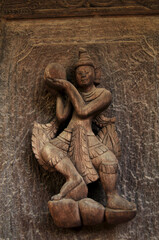 Wooden figure deity carving of Teakwood temple of Mandalay or Shwenandaw Monastery or Golden Palace Monastery for burmese people and foreign travelers travel visit in Mandalay of Myanmar or Burma