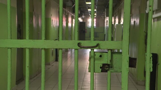 Prison doors. Prison corridor, the iron door of the prison is closing. Pre-trial detention center.