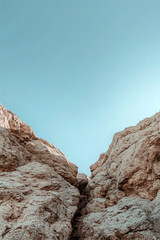 Fototapeta premium Minimal rock formation with clear blue sky background in natural desert landscape