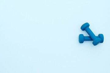 Dumbbells on turquoise background with free space for text layout