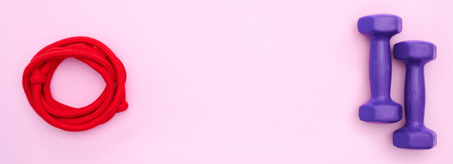 purple dumbbells and a stylish skipping rope arranged on a pink backdrop, forming a dynamic flat lay that captures the essence of health and exercise, with plenty of room for copy and creative content