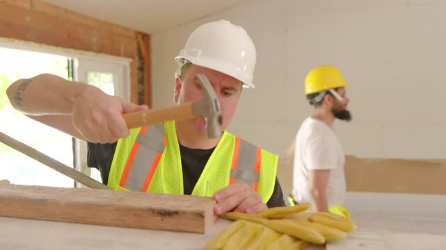 Diverse team of builders, including African American, Hispanic, and Caucasian members, is engaged in construction at a renovation site, showcasing teamwork and commitment to excellence