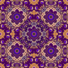 A lilac floral pattern that fills with energy. Fairytale seamless print in ethnic style with bright purple mandalas for tablecloth, carpet, scarf, bed linen, bedspread.