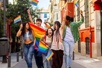 Young activists celebrating with rainbow flags at pride parade