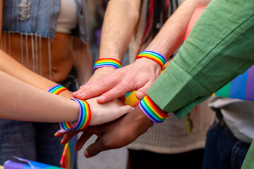 Activists showing support and solidarity at pride parade with rainbow bracelets