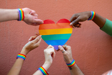 Activists holding rainbow heart symbol of lgbtq plus community