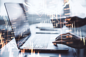 Businessperson analyzing forex and stock market data on laptop with financial chart overlay on light background, symbolizing digital economy growth.