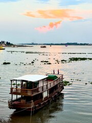 Traditional Khmer boat anchored at the banks of the Mekong river in Phnom Penh, Cambodia