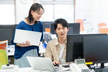 オフィスで働く若い男女のエンジニア