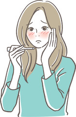 熱っぽい顔で体温計を見る女性
