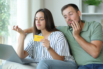 Bored couple wasting time waiting for online payment