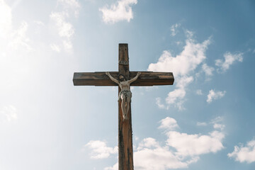 Crucifixion of Christ against the sky background. Catholicism, Christianity, faith concept. The initialism INRI Iesus Nazarenus, Rex Iudaeorum represents the Latin inscription in English translates to