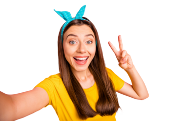 Close up photo of cheerful lady with blue headband making v-signs wearing yellow t-shirt isolated over pink background