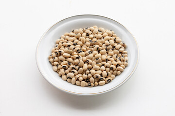 Yellow Beans Arranged in Ceramic Plate Resting on White Background Representing Healthy Food and Nutrition Concept