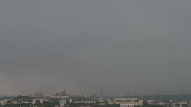 Lightning storm over city at sunset.