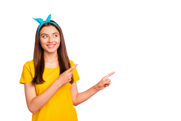 Portrait of attractive lady showing promotion with her finger looking wearing yellow t-shirt isolated over pink background